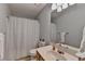 Neutral bathroom featuring a shower with tub and updated single sink at 4995 Hyde Ct, Cumming, GA 30040