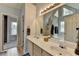 Bright bathroom with double sinks, a large mirror, vanity lighting, and a soaking tub at 4995 Hyde Ct, Cumming, GA 30040