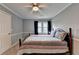 Comfortable bedroom with carpet, ceiling fan, window and craftsman trim at 4995 Hyde Ct, Cumming, GA 30040