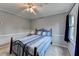 Cozy bedroom featuring a queen-sized bed, soft carpeting, and a ceiling fan at 4995 Hyde Ct, Cumming, GA 30040