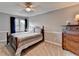 Comfortable bedroom with carpet, ceiling fan, window and craftsman trim at 4995 Hyde Ct, Cumming, GA 30040