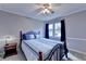Cozy bedroom featuring a large window and hardwood furniture at 4995 Hyde Ct, Cumming, GA 30040