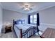 Cozy bedroom featuring a large window and hardwood furniture at 4995 Hyde Ct, Cumming, GA 30040