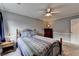Cozy bedroom with ceiling fan and accenting side table and chest of drawers at 4995 Hyde Ct, Cumming, GA 30040