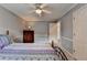 Cozy bedroom with ceiling fan and accenting side table and chest of drawers at 4995 Hyde Ct, Cumming, GA 30040