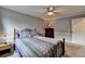 Cozy bedroom with ceiling fan and accenting side table and chest of drawers at 4995 Hyde Ct, Cumming, GA 30040