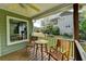 Charming covered porch featuring a table and two chairs, great for enjoying the peaceful backyard scenery at 4995 Hyde Ct, Cumming, GA 30040