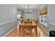 Charming dining room with hardwood floors, chandelier, and plenty of natural light at 4995 Hyde Ct, Cumming, GA 30040