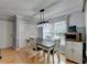 Bright breakfast nook with a table for four, storage cabinets, and a large window at 4995 Hyde Ct, Cumming, GA 30040