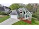 Charming home showcasing a two-car garage and outdoor deck, surrounded by a well-maintained lawn and mature trees at 4995 Hyde Ct, Cumming, GA 30040