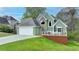 Charming two-story home featuring a two-car garage and a cozy front deck for outdoor relaxation at 4995 Hyde Ct, Cumming, GA 30040