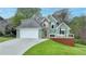 Charming two-story home featuring a two-car garage and a cozy front porch for outdoor relaxation at 4995 Hyde Ct, Cumming, GA 30040