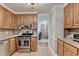 Well-lit kitchen with wood cabinets, stainless steel appliances, granite countertops, and tile backsplash at 4995 Hyde Ct, Cumming, GA 30040