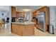 Kitchen with wood cabinets, stainless steel appliances, granite countertops, and a kitchen island at 4995 Hyde Ct, Cumming, GA 30040