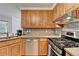 Well-equipped kitchen showcasing stainless steel appliances, granite countertops, and wood cabinets at 4995 Hyde Ct, Cumming, GA 30040