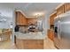 Kitchen with wood cabinets, stainless steel appliances, granite countertops, and an island at 4995 Hyde Ct, Cumming, GA 30040