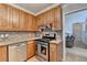 Stylish kitchen featuring stainless steel appliances, granite countertops, and wood cabinets at 4995 Hyde Ct, Cumming, GA 30040