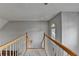 Well-lit stairway with white railings and carpeted steps leading to the lower level at 4995 Hyde Ct, Cumming, GA 30040