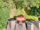 Aerial view of backyard with deck, lush lawn, mature trees, and brown shingled roof at 2570 Middleton Way, Grayson, GA 30017