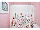 Quaint bathroom with pink walls and shower with floral curtain at 2570 Middleton Way, Grayson, GA 30017