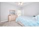 Bright bedroom with carpet floors, a ceiling fan, and a light wood dresser and mirror at 2570 Middleton Way, Grayson, GA 30017