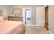 Bedroom with an ensuite bathroom featuring neutral walls, carpet flooring, and soft pink accents in the bed linens at 2570 Middleton Way, Grayson, GA 30017