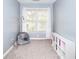 Cozy bedroom featuring a window with curtains, carpeted floors, and a white bookshelf at 2570 Middleton Way, Grayson, GA 30017