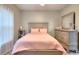 Bedroom featuring neutral walls, carpet flooring, and a bed dressed in soft pink linens at 2570 Middleton Way, Grayson, GA 30017