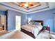 Spacious blue primary bedroom with a trey ceiling, an ensuite bathroom, and carpet floors at 2570 Middleton Way, Grayson, GA 30017