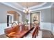 Formal dining room with wood trim, chandelier, and access to adjoining rooms at 2570 Middleton Way, Grayson, GA 30017