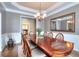 Elegant dining room featuring wainscoting, a chandelier, and a large mirror at 2570 Middleton Way, Grayson, GA 30017