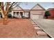 Traditional brick home with a two-car garage, inviting front porch and concrete steps to driveway at 2570 Middleton Way, Grayson, GA 30017