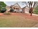 Charming brick home featuring a covered porch with classic columns and landscaped front yard at 2570 Middleton Way, Grayson, GA 30017