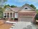 Charming brick home featuring manicured landscaping and an attached two-car garage at 2570 Middleton Way, Grayson, GA 30017