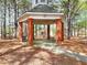 Community gazebo amongst tall trees, with tables and benches visible inside at 2570 Middleton Way, Grayson, GA 30017