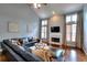 Bright living room boasts high ceilings, fireplace, hardwood floors, and large windows at 2570 Middleton Way, Grayson, GA 30017