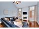 Bright living room boasts high ceilings, fireplace, hardwood floors, and large windows at 2570 Middleton Way, Grayson, GA 30017