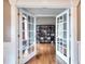 Office space featuring double doors, hardwood floors, white trim and a built-in bookshelf at 2570 Middleton Way, Grayson, GA 30017