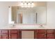 Bathroom featuring double vanity, and a large mirror reflecting additional doors in the house at 3019 Iona Ct, Snellville, GA 30039