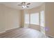 Bright bedroom features wood-look flooring and three windows offering natural light at 3019 Iona Ct, Snellville, GA 30039