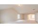 Large bonus room features vaulted ceilings and ample natural light from two windows at 3019 Iona Ct, Snellville, GA 30039