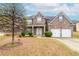Charming brick home featuring a two-car garage, well-manicured lawn, and inviting front porch at 3019 Iona Ct, Snellville, GA 30039