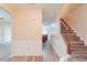 Open foyer featuring hardwood floors, wainscoting, and a staircase with a wood banister at 3019 Iona Ct, Snellville, GA 30039