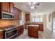 Stylish kitchen featuring stainless steel appliances, granite counters, and dark cabinetry at 3019 Iona Ct, Snellville, GA 30039