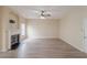 Open living room with a fireplace, white mantle, and gray wood-look flooring at 3019 Iona Ct, Snellville, GA 30039