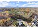 An aerial view showcasing the neighborhood surrounded by vibrant fall foliage and rolling hills at 4835 Fields Bridge Rd, Cumming, GA 30028