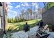 Backyard area featuring outdoor seating, landscaping, a fire pit, and a grill, creating an inviting space at 4835 Fields Bridge Rd, Cumming, GA 30028