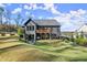 Expansive backyard featuring a well-manicured lawn, deck, and patio space, perfect for outdoor living and entertaining at 4835 Fields Bridge Rd, Cumming, GA 30028