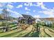 The landscaped backyard features multi-tiered terraced planting beds and a spacious manicured lawn at 4835 Fields Bridge Rd, Cumming, GA 30028