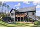 Lovely backyard featuring an elevated deck, a covered patio, and a well-maintained lawn at 4835 Fields Bridge Rd, Cumming, GA 30028